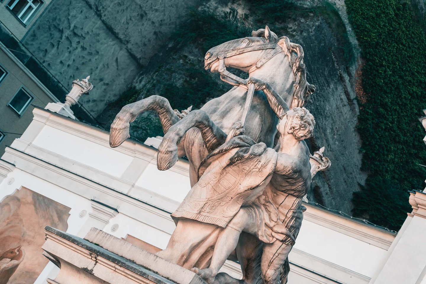 Rearing horse and groom statue of Pferdeschwemme seen from below in Salzburg old town