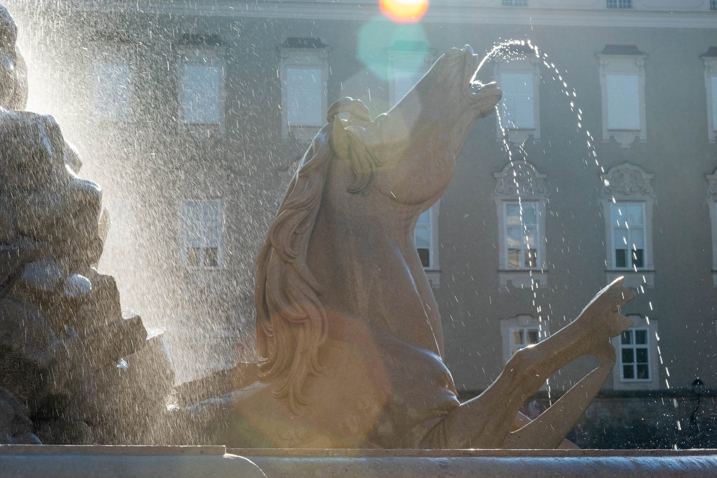 Baroque horse sculpture spouting water at Residenzbrunnen fountain on Residenzplatz in Salzburg