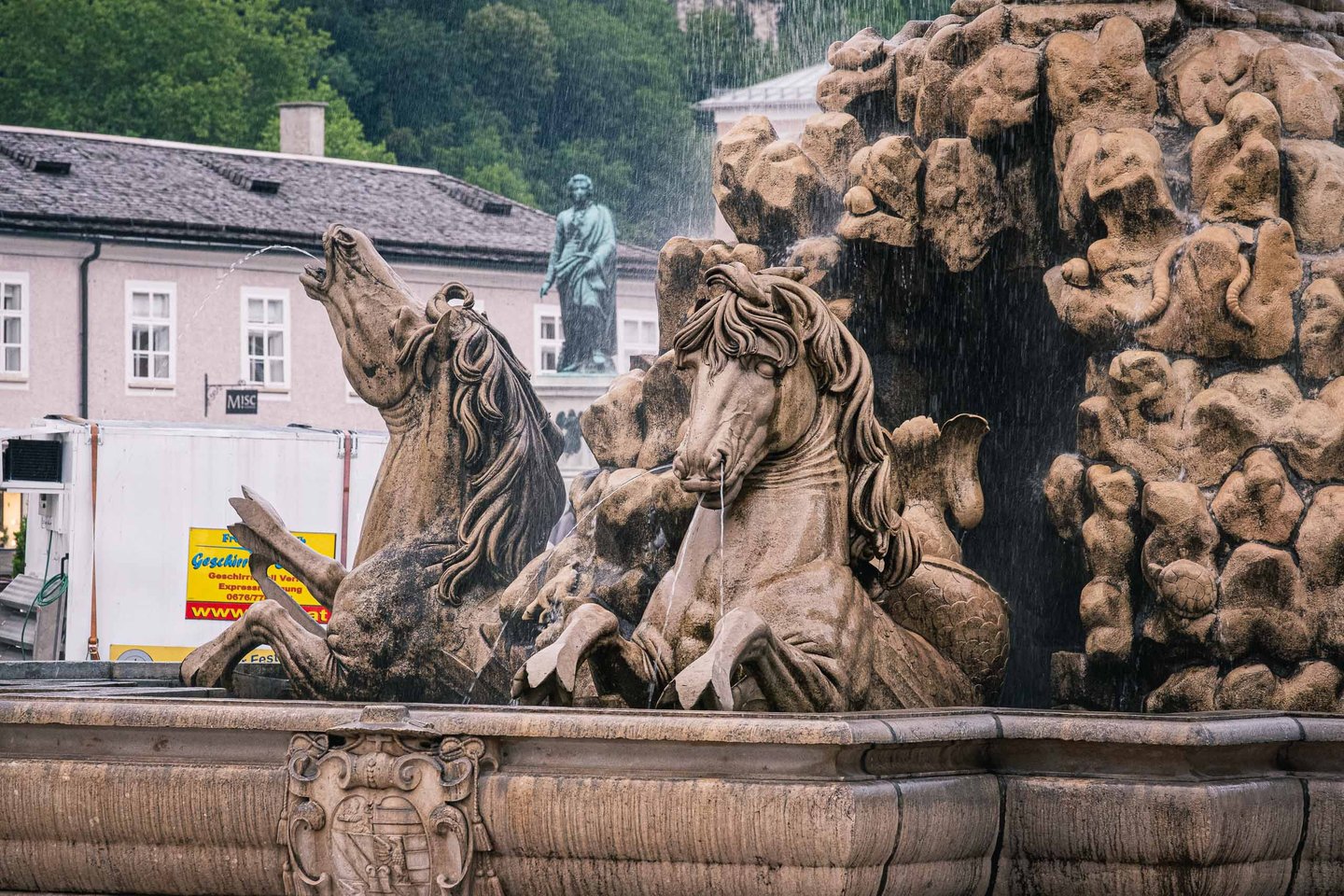 Rearing horses and tritons with water jets on the Residenzbrunnen fountain in Salzburg old town