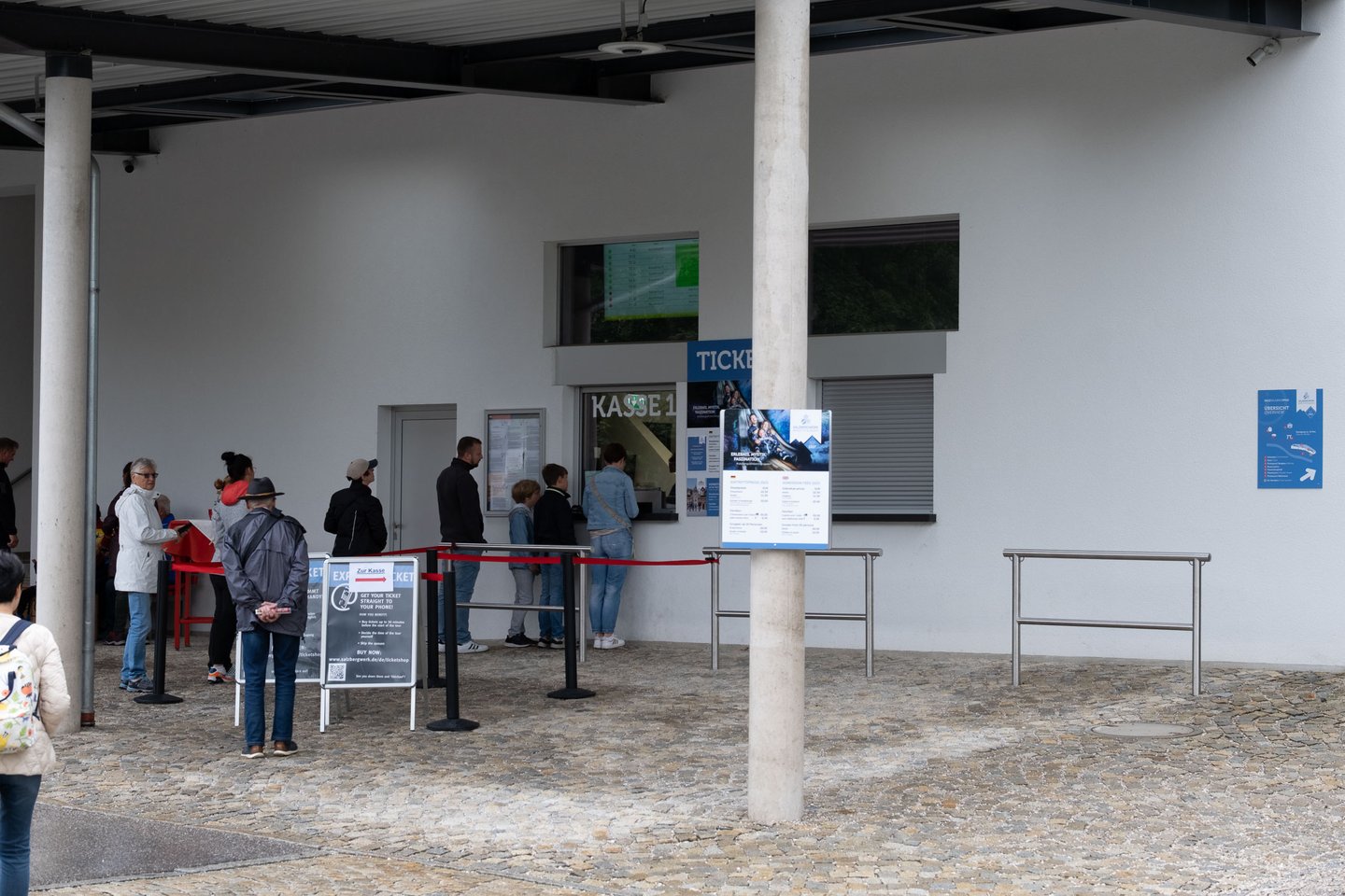 Visitors queue at the ticket counter of the Salzbergwerk Berchtesgaden salt mine entrance