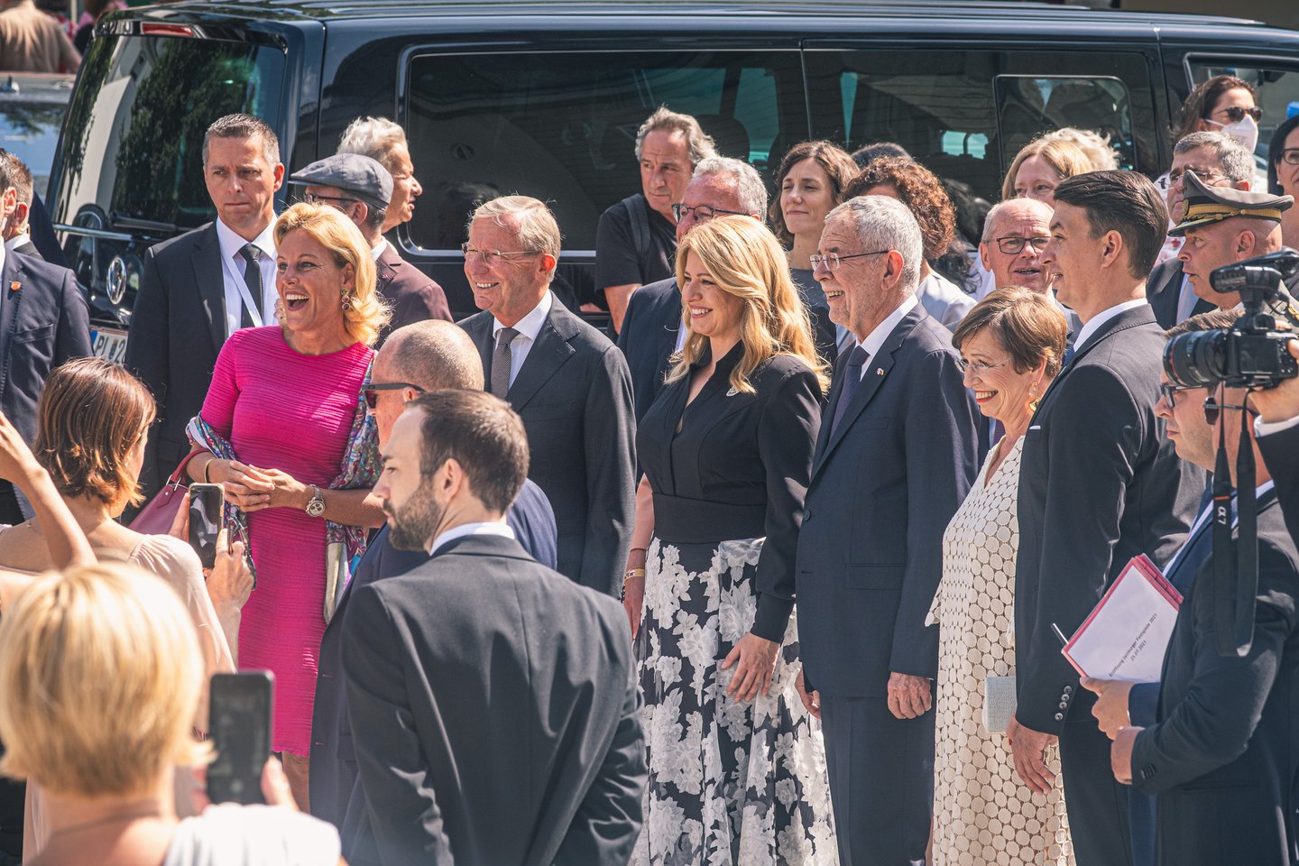 Official guests, among them Austrian Federal President Alexander Van der Bellen, line up for photographers in the sun at the opening of the Salzburg Festival.