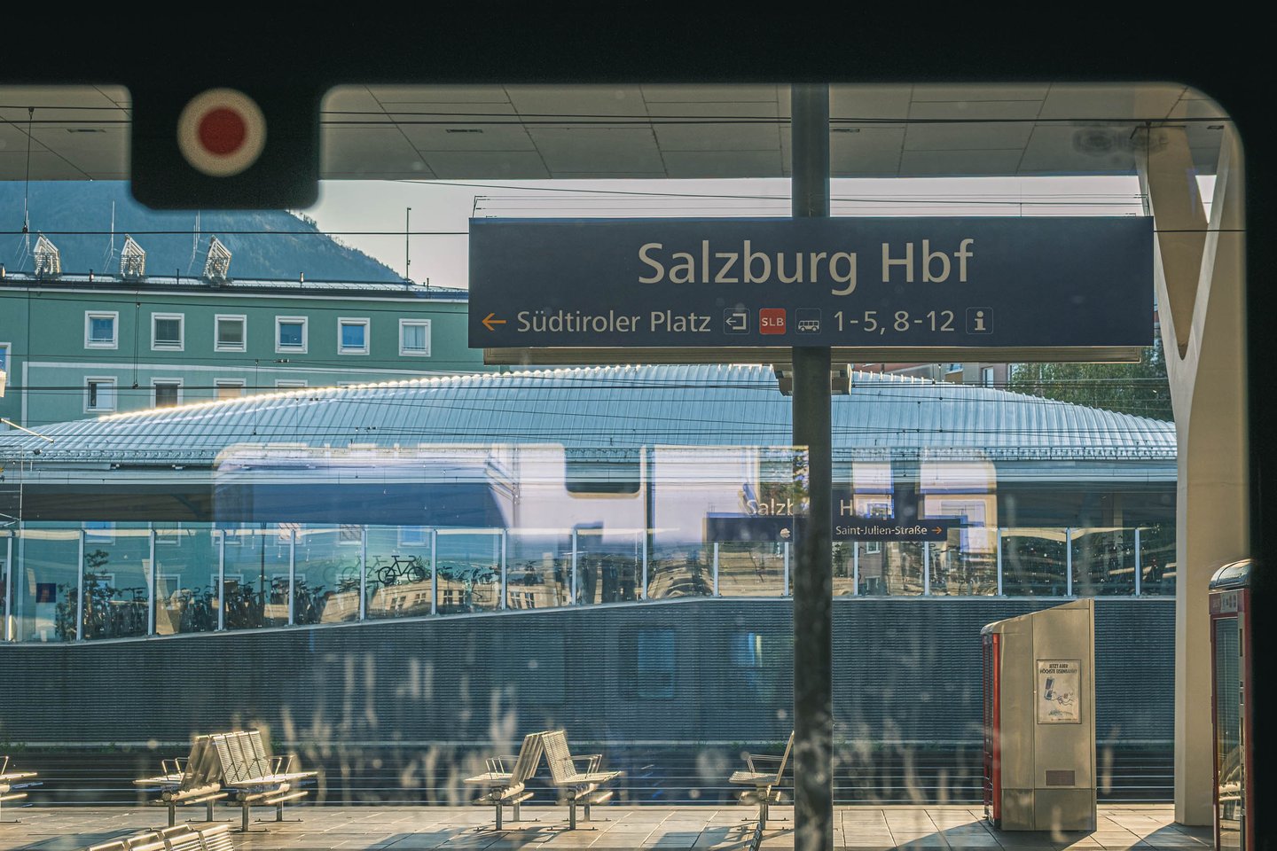 Salzburg Hauptbahnhof platform with station sign toward Suedtiroler Platz and arched roof in Salzburg