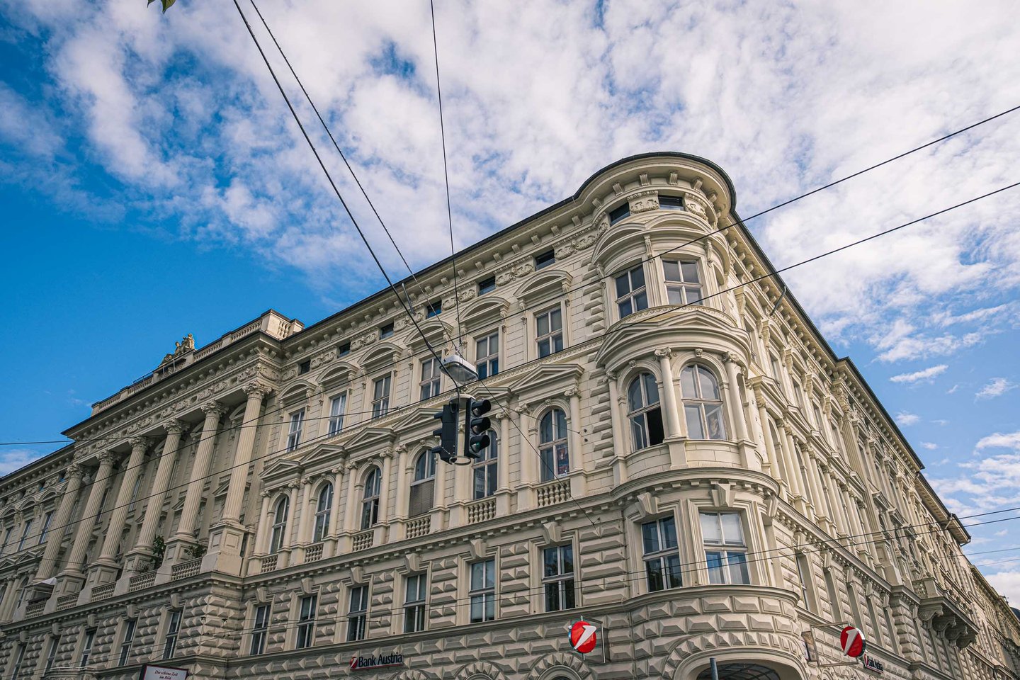 Neustadt corner building with Bank Austria branch on ground floor and ornate historicist facade in Salzburg.