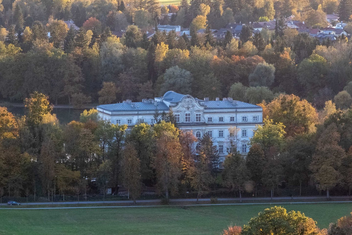 Schloss Leopoldskron palace framed by autumn trees in the quiet suburb of Leopoldskron-Moos in Salzburg.