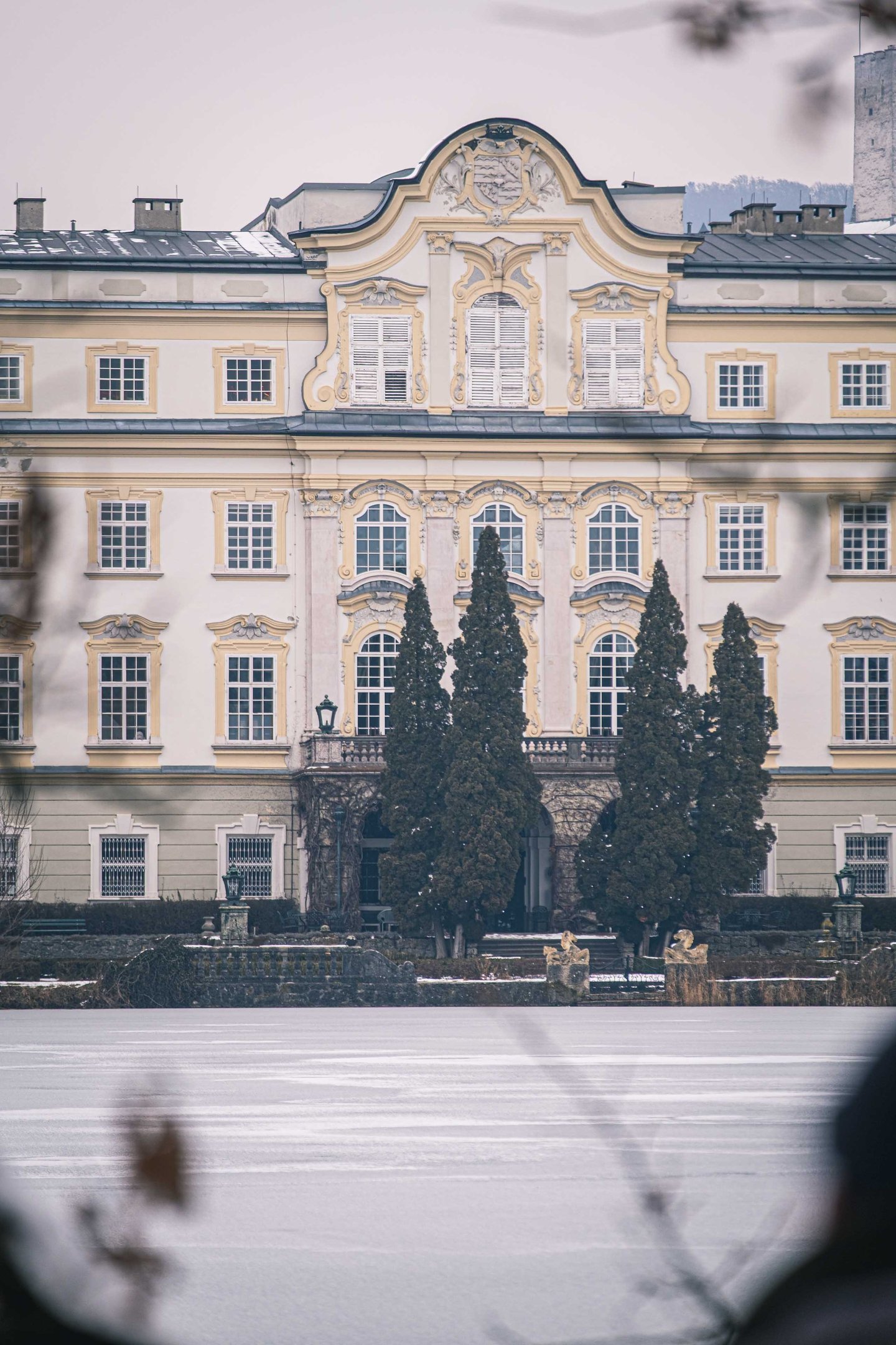 Ornate Baroque pediment and windows on the central facade of Schloss Leopoldskron in Salzburg.