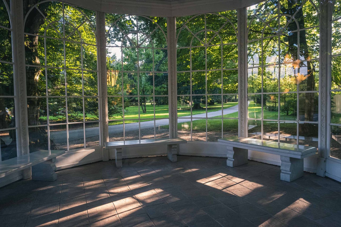 Stone benches inside the Sound of Music glass pavilion at Hellbrunn gardens in Salzburg.