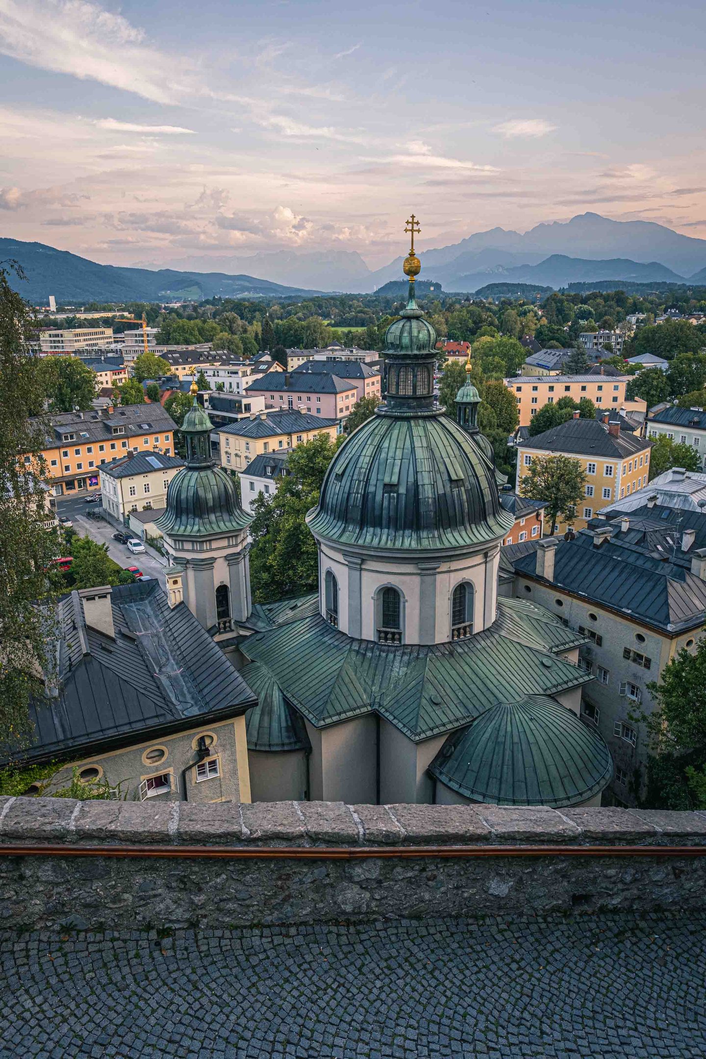 Erhardkirche green dome with cross crowns Nonntal quarter below the Untersberg in Salzburg.