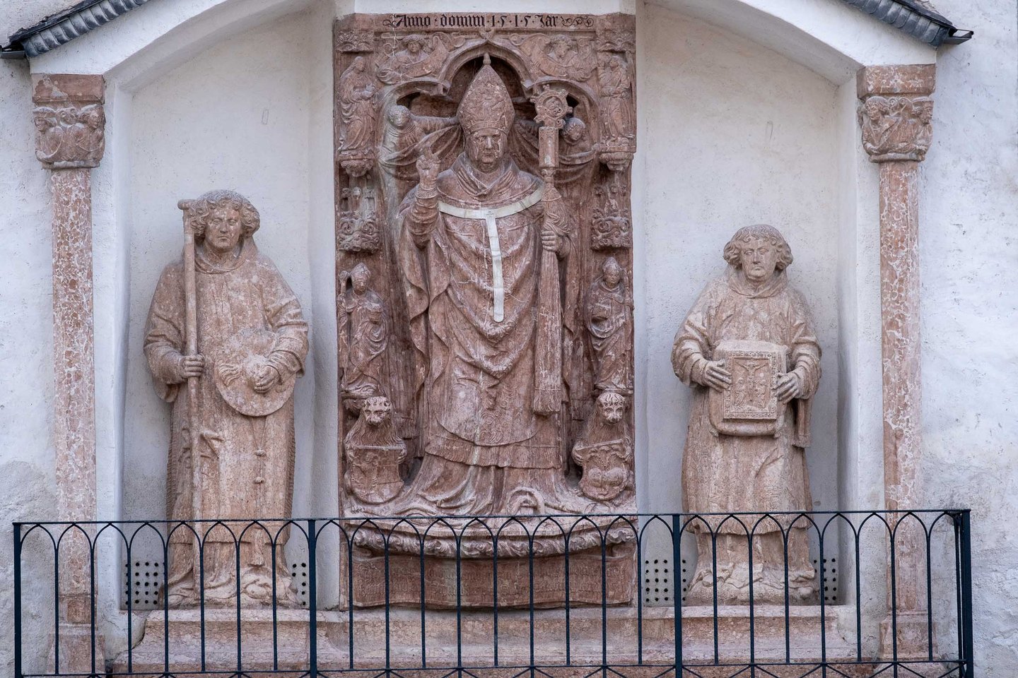 Renaissance stone relief of a bishop saint flanked by two figures with Anno Domini 1515 inscription at St Georges Chapel inside Hohensalzburg Fortress (Leonhard von Keutschach)
