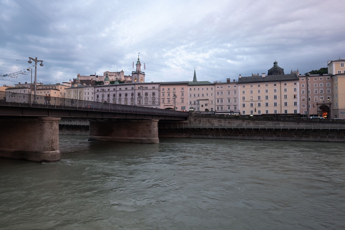 Staatsbruecke bridge over the Salzach with the old town skyline and fortress in Salzburg.