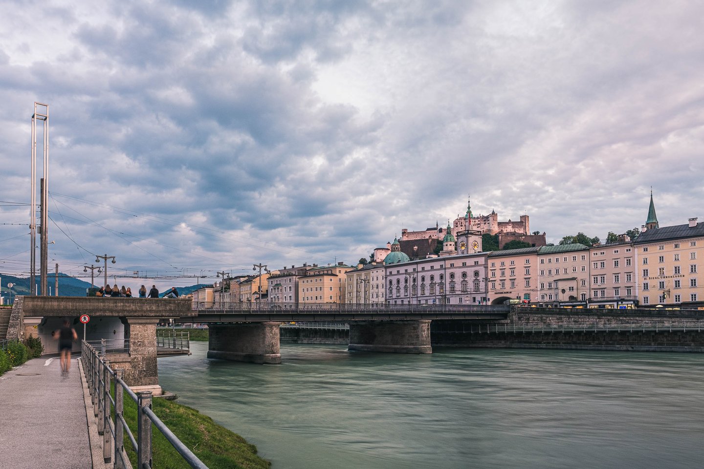 Staatsbruecke crossing the Salzach with Hohensalzburg Fortress rising above the old town in Salzburg.