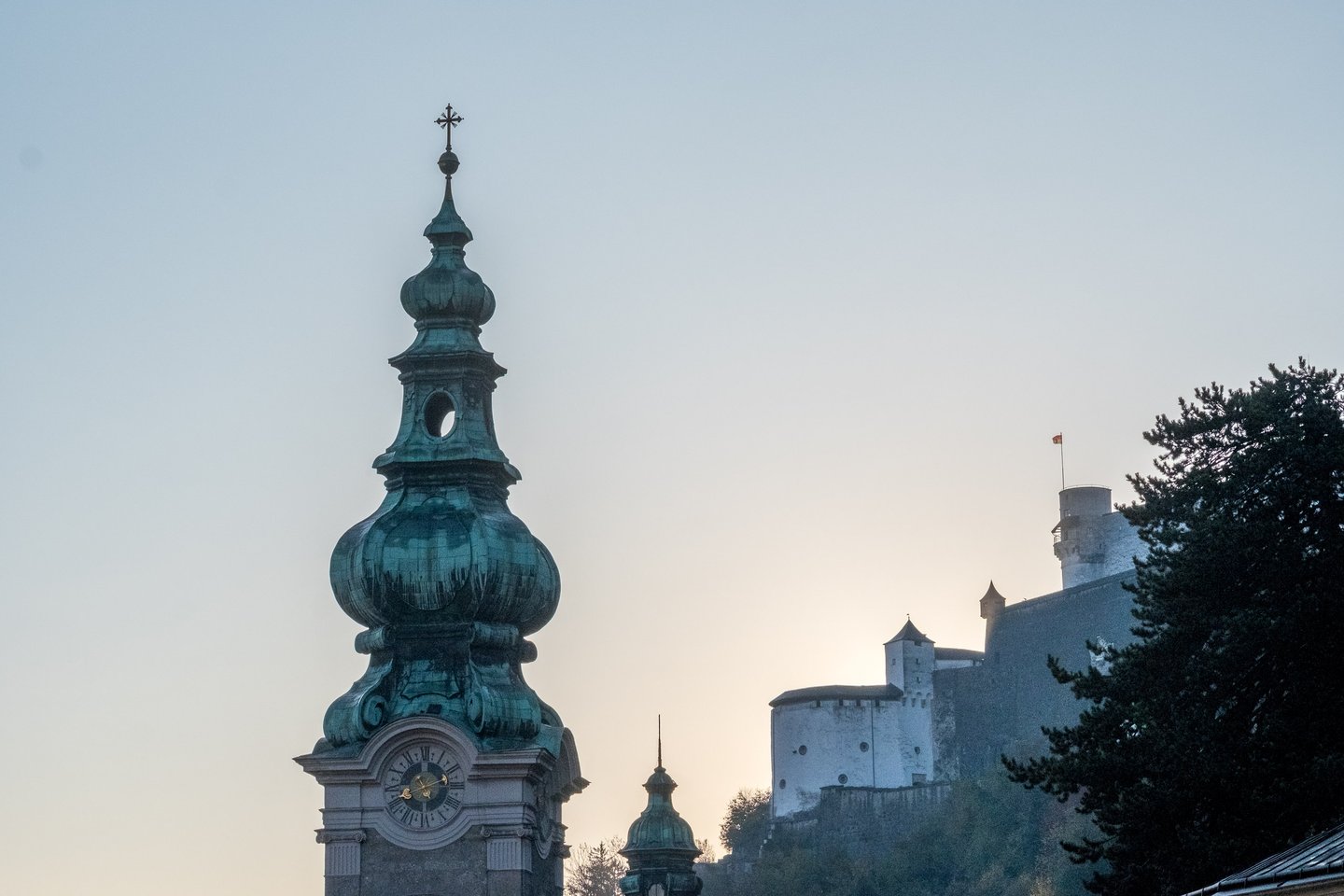 St Peter abbey bell tower with Hohensalzburg Fortress behind in Salzburg old town.