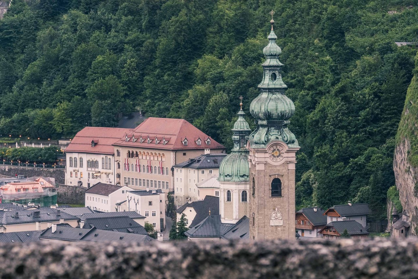 Twin onion-domed bell tower of Stift St Peter with the connected monastery complex behind