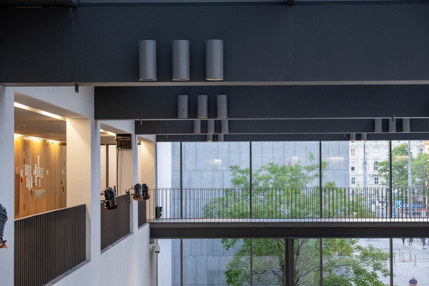 Modern multi-level interior of the Universitaet Mozarteum with concrete pillars and dark beams in Salzburg
