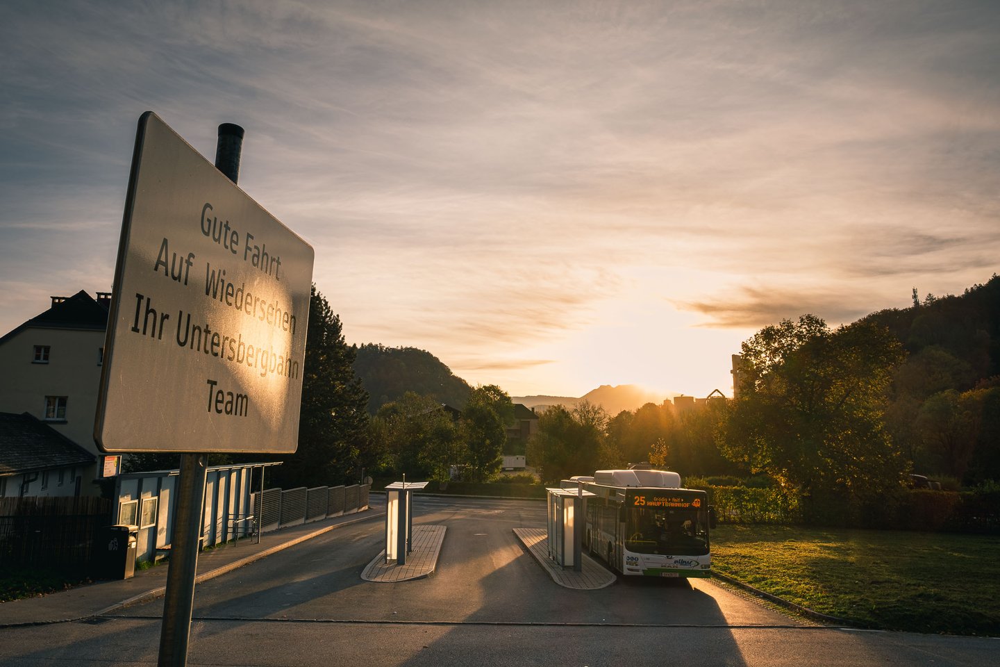 Bus 25 at the Untersbergbahn terminus with goodbye sign at sunrise in Groedig