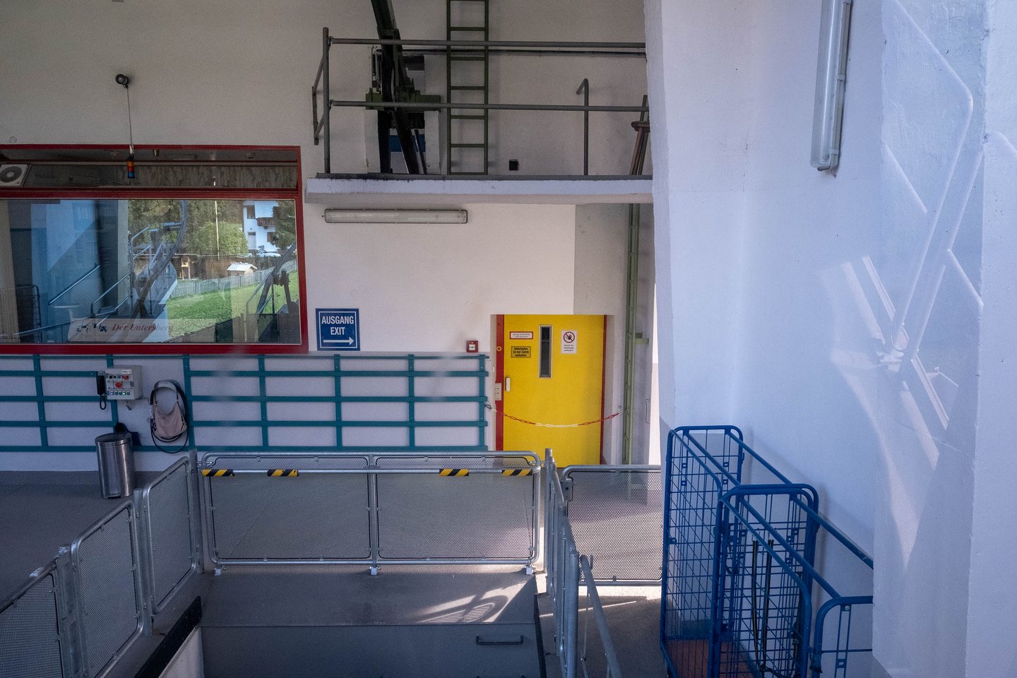 Interior of Untersbergbahn valley station with boarding platform and exit door in Grodig