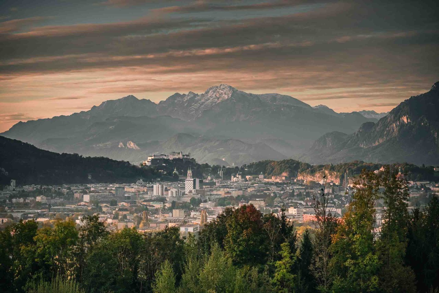 Sunset view from Maria Plain hill over Salzburg city toward Hohensalzburg and Untersberg.