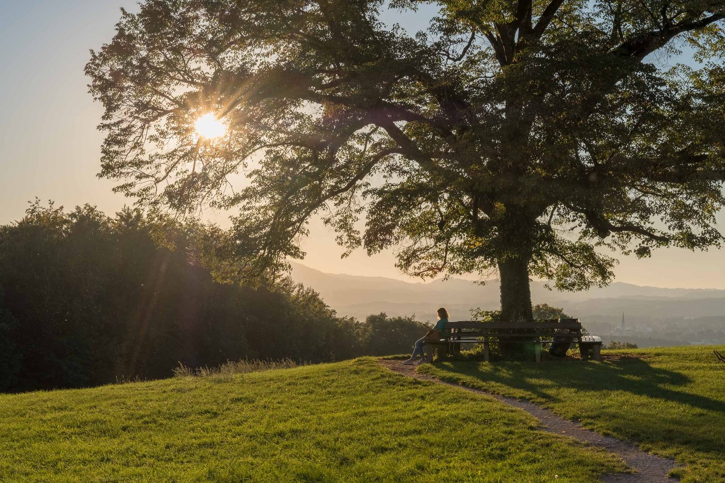 Bench vantage view from the Maria Plain pilgrimage hill in Salzburg at sunset