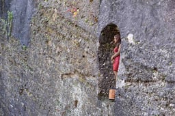 Frau im Fels sculpture by Stephan Balkenhol set into a rock niche on the Festungsberg in Salzburg, paired companion to the Sphaera on Kapitelplatz