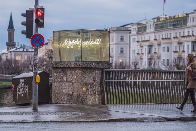 Beyond Recall neon memorial cube by Brigitte Kowanz at the Staatsbruecke bridgehead in Salzburg
