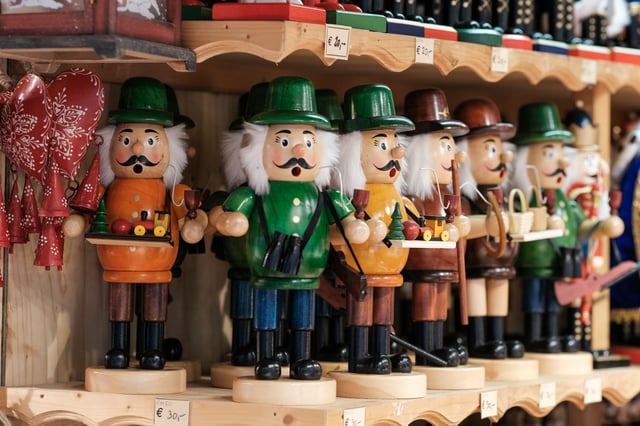Wooden nutcracker figures on display at a Christmas market stall in Salzburg old town.