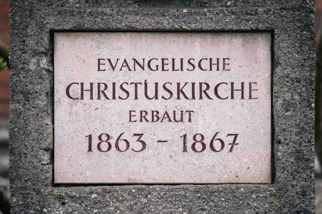 Stone plaque reading Evangelische Christuskirche erbaut 1863 to 1867 in Salzburg