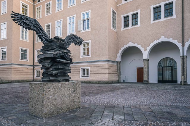 Anselm Kiefer Die Sprache der Voegel sculpture with bronze book stack and winged figure in Salzburg.