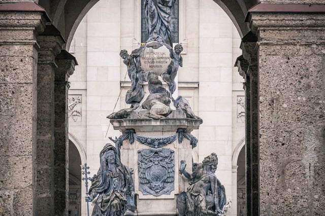 Marian Column framed through the baroque arches of Domplatz in Salzburg old town