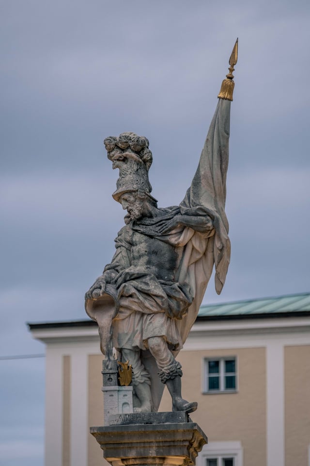 Stone statue of Saint Florian atop the Florianibrunnen fountain on Alter Markt in Salzburg