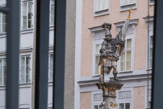 Saint Florian statue atop the Florianibrunnen column on Alter Markt in Salzburg old town