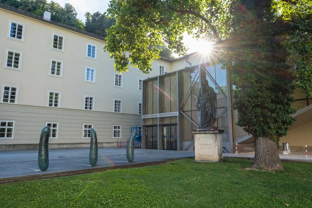 Friedrich Schiller statue and bronze Gurken pickle sculptures in Furtwaenglerpark at Salzburg University.