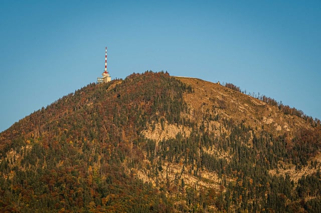 Gaisberg summit with radio transmission tower and autumn-colored forest slopes near Salzburg.