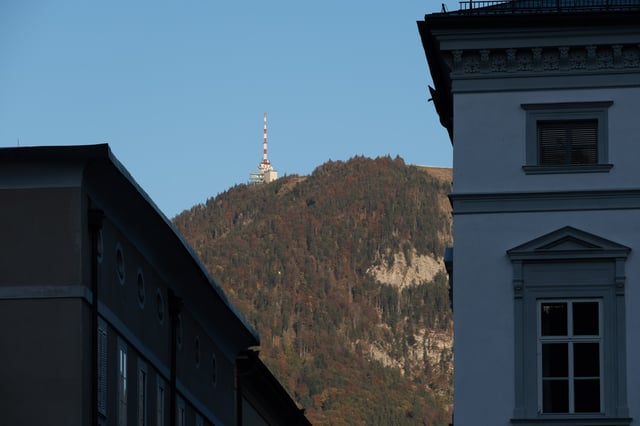 Gaisberg summit with radio transmission tower framed between buildings in Salzburg old town.