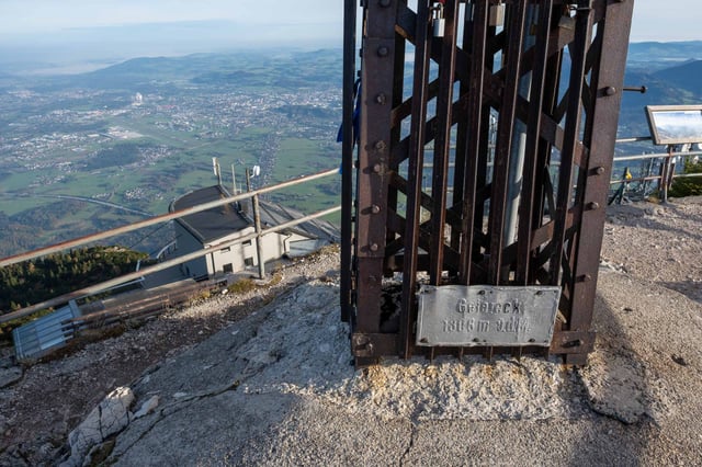 Geiereck summit plaque at 1806 meters with the Untersbergbahn top station and Salzburg basin below.