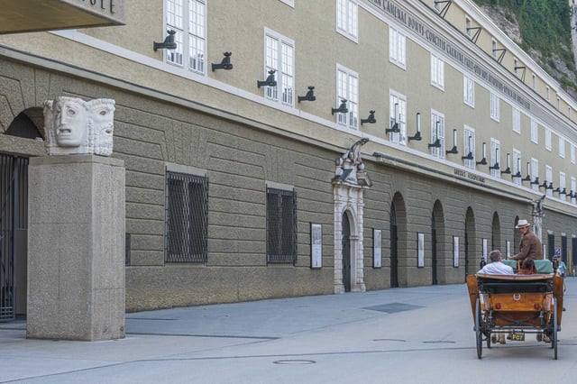 Festspielhaus facade with Karajan stone mask sculpture on Hofstallgasse in Salzburg