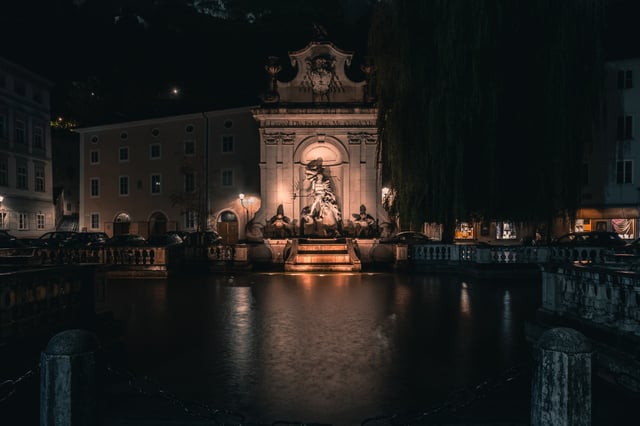 Kapitelschwemme horse pond with Leopold fountain illuminated at night in Salzburg old town