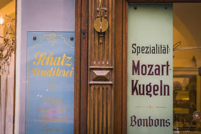 Schatz Konditorei storefront with Mozartkugeln advertisement in Salzburg old town