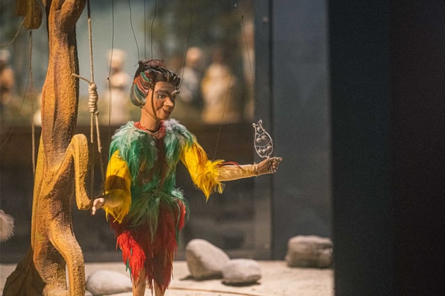 Papageno marionette from Mozarts Magic Flute holding a bird on display at the Marionette Museum Salzburg.