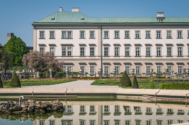 Mirabell Palace reflected in the Pegasus pond of Mirabell Gardens in Salzburg.