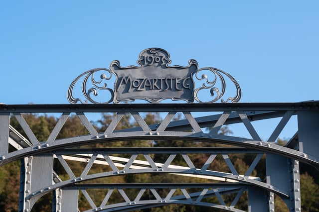 Art nouveau MOZARTSTEG sign crowning the iron footbridge over the Salzach in Salzburg.