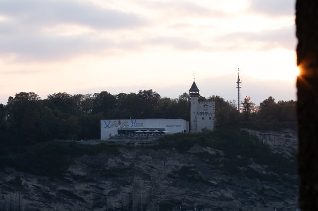 Museum der Moderne and the old water tower on the Moenchsberg cliff glow at sunset in Salzburg