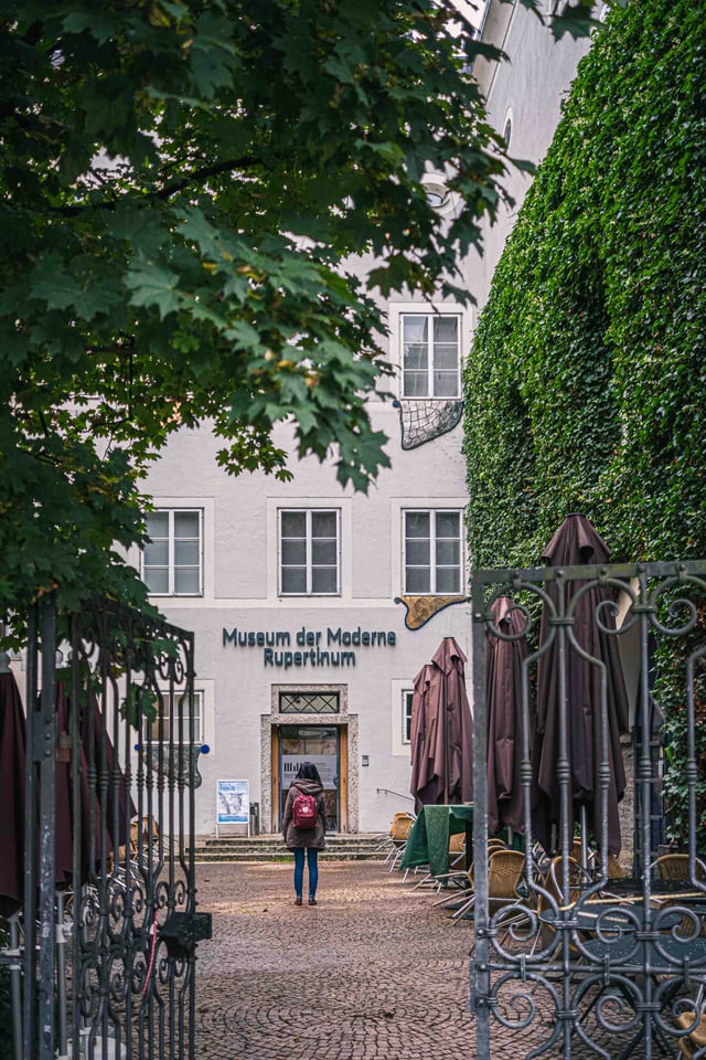 Ivy-covered wall beside the Museum der Moderne Rupertinum entrance in Salzburg old town.