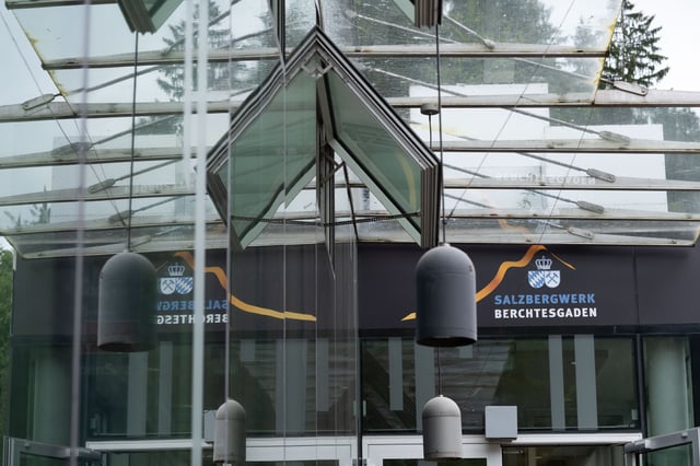 Glass entrance pavilion of the Salzbergwerk Berchtesgaden with crown logo signage in Bavaria