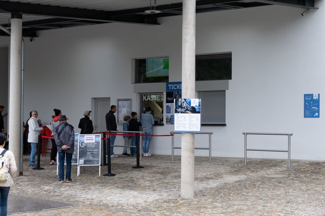 Visitors queue at the ticket counter of the Salzbergwerk Berchtesgaden salt mine entrance