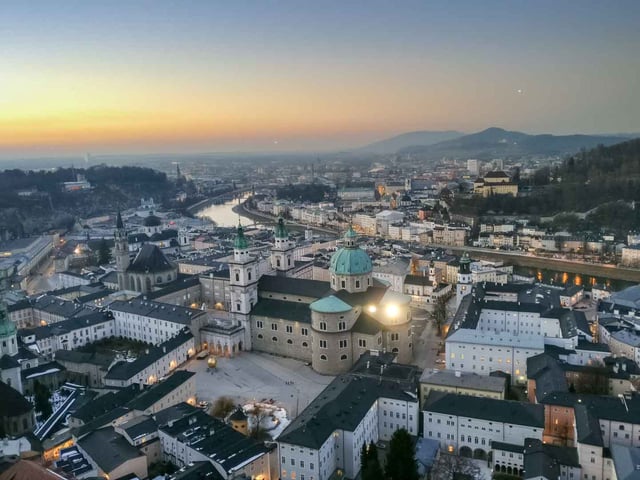 Aerial view of Salzburg old town with the cathedral and domes at dusk in Salzburg
