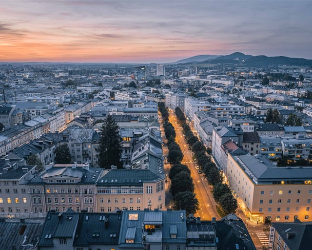 Aerial dusk view of Salzburg Neustadt streets with Gaisberg on the horizon from Kapuzinerberg