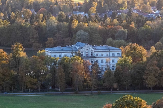 Schloss Leopoldskron palace framed by autumn trees in the quiet suburb of Leopoldskron-Moos in Salzburg.