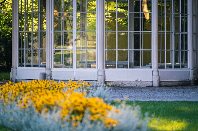 Lower section of the Sound of Music pavilion with yellow flowers in foreground at Hellbrunn Salzburg.