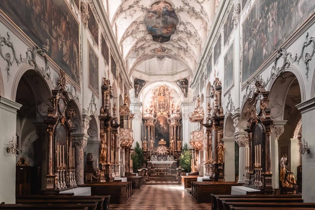 Baroque interior of Stift St Peter abbey church with side altars and frescoed ceiling in Salzburg