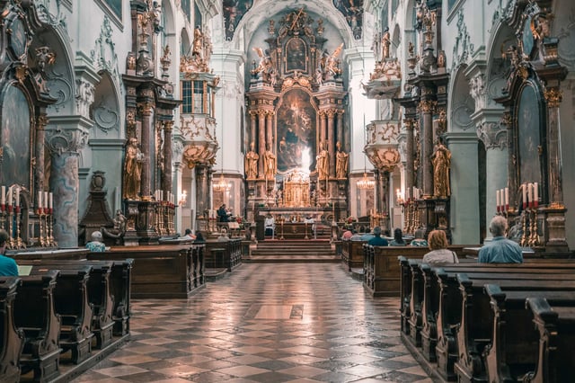 Interior nave of Stift St Peter with altar and congregation during service in Salzburg old town